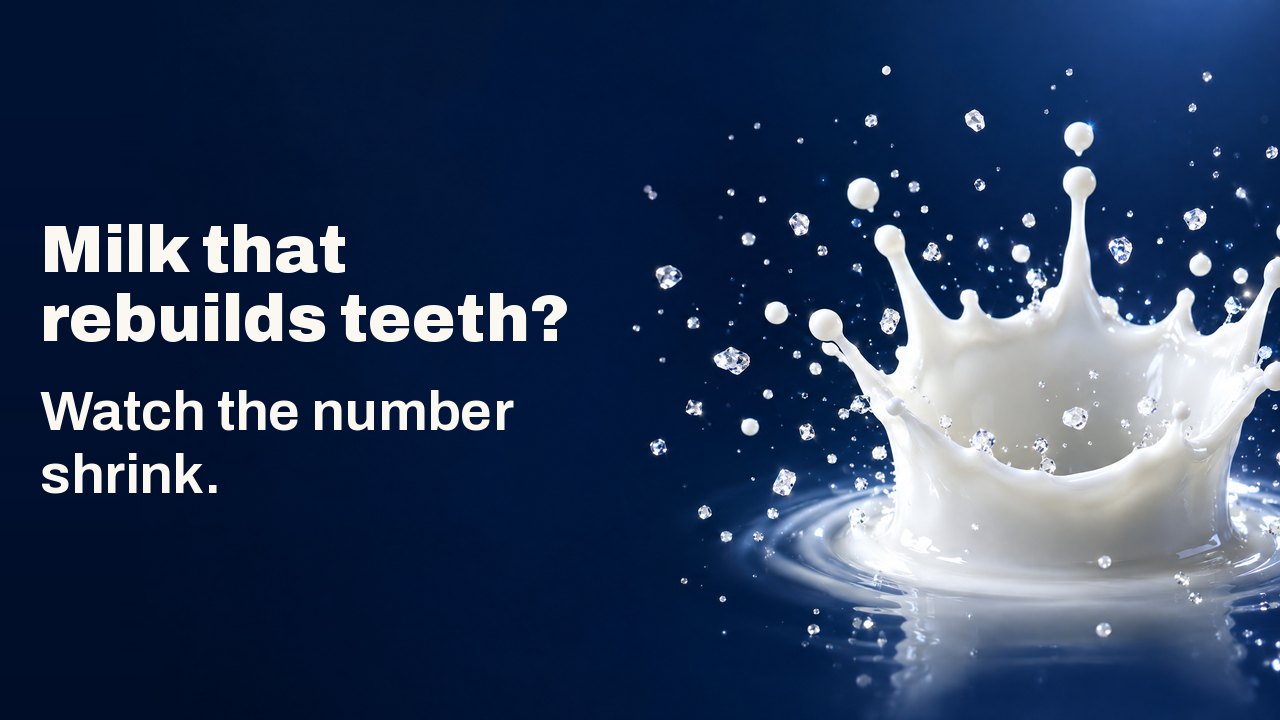 Milk that rebuilds teeth? Watch the number shrink. A milk drop crown splash frozen in mid air with tiny sparkling crystals, on a deep navy background.