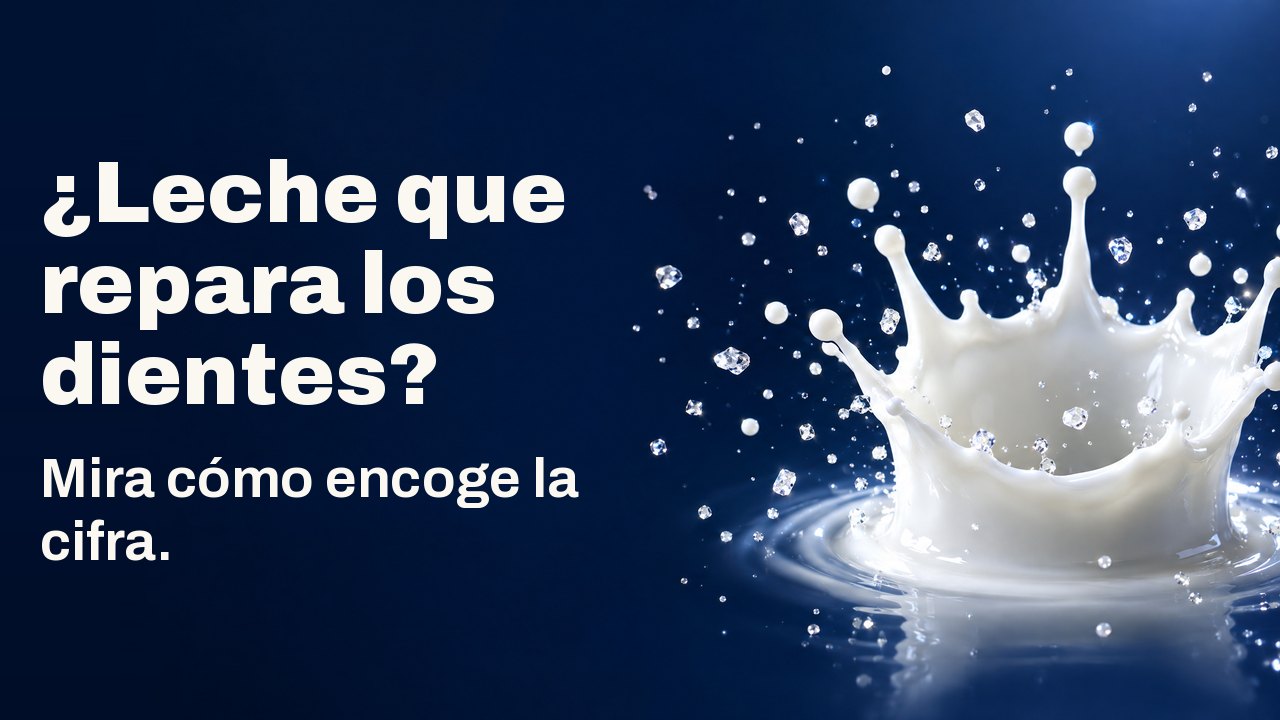 ¿Leche que repara los dientes? Mira cómo encoge la cifra. Una corona de gota de leche congelada en el aire con diminutos cristales brillantes, sobre azul marino intenso.