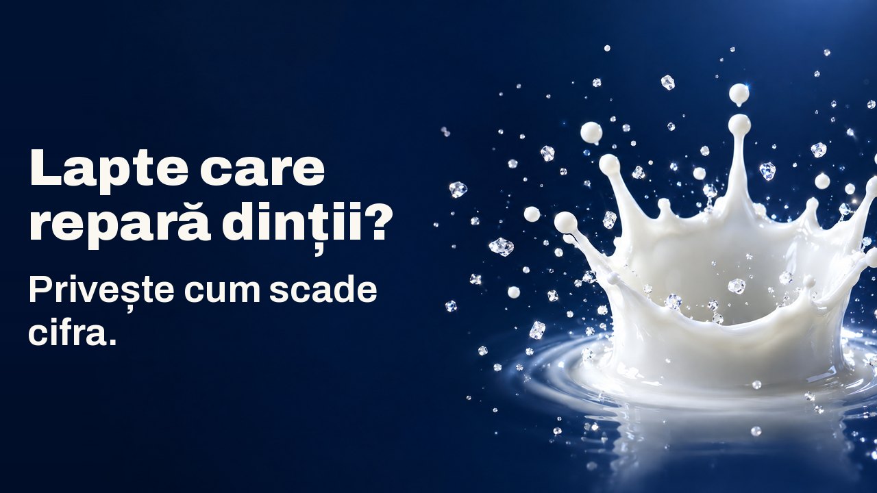 Lapte care repară dinții? Privește cum scade cifra. O coroană din picătura de lapte înghețată în aer, cu cristale mici sclipitoare, pe bleumarin intens.