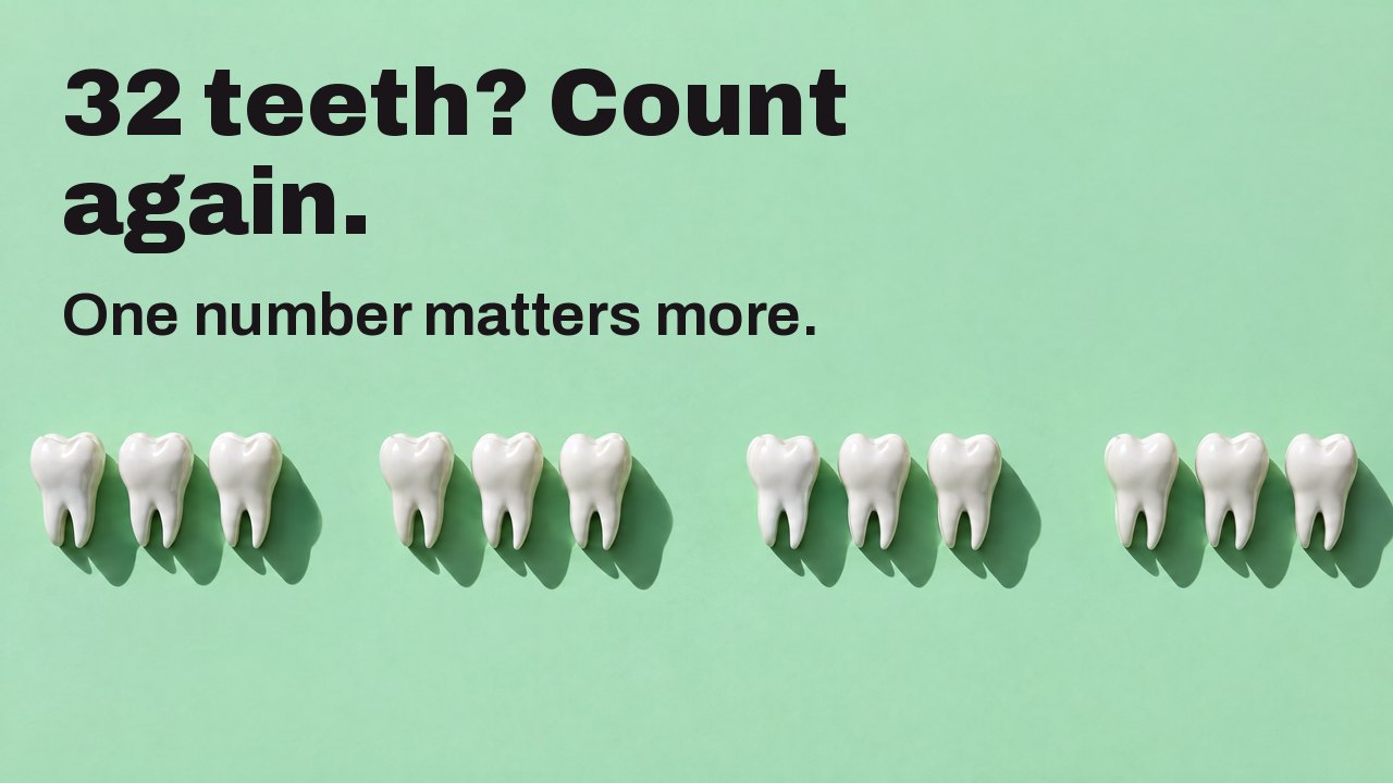 32 teeth? Count again. One number matters more. Seen from above: a row of white tooth sculptures on mint green, with gaps where teeth are missing.